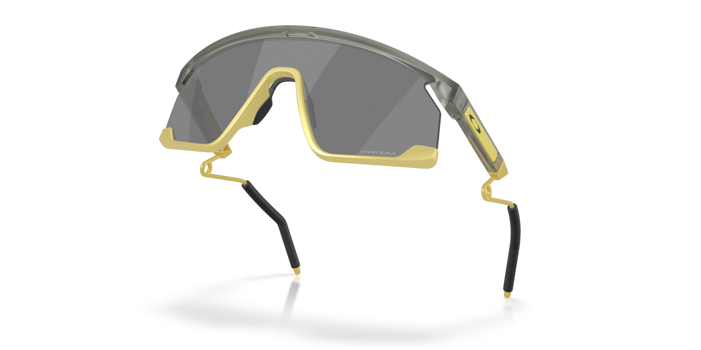 Oakley Sunglass BXTR Metal Alloy Collection prizm black Lenses With matte grey ink/vintage gold Frame